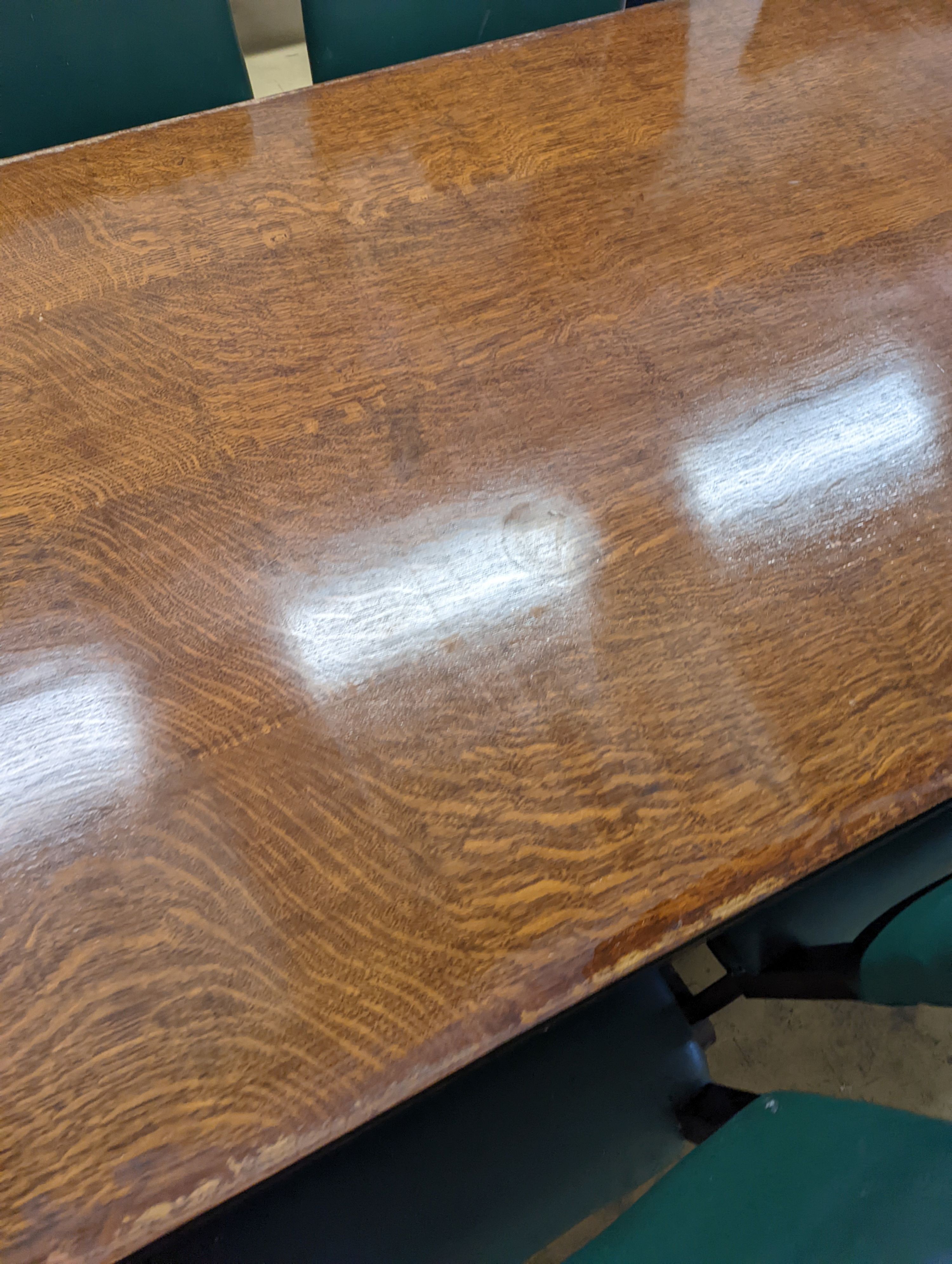 An early 20th century oak dining suite comprising rectangular table, length 216cm, width 106cm, height 74cm together with eight 'X' frame chairs and serving table